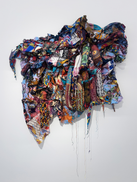 Jamele Wright Sr., Levitate 12, 2025, Mixed media; Georgia red clay, dutch wax cloth, 58″ x 53″ x 9″