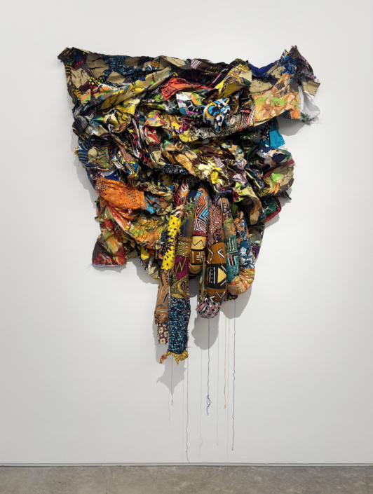 Jamele Wright Sr., Levitate 15, 2025, Mixed media; Georgia red clay, dutch wax cloth, 56″ x 50″ x 11″