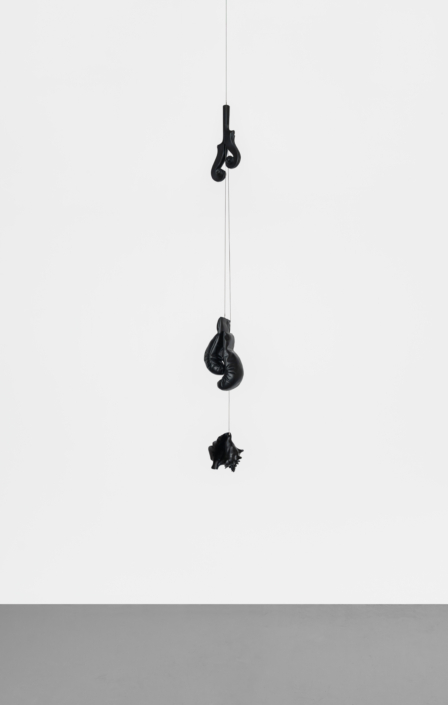 Christine Rebhuhn, Across the Long Ocean, 2026, Carved wood conch shell, carved wood boxing gloves, cello necks, paint, cable, 108″ x 12″ x 12″