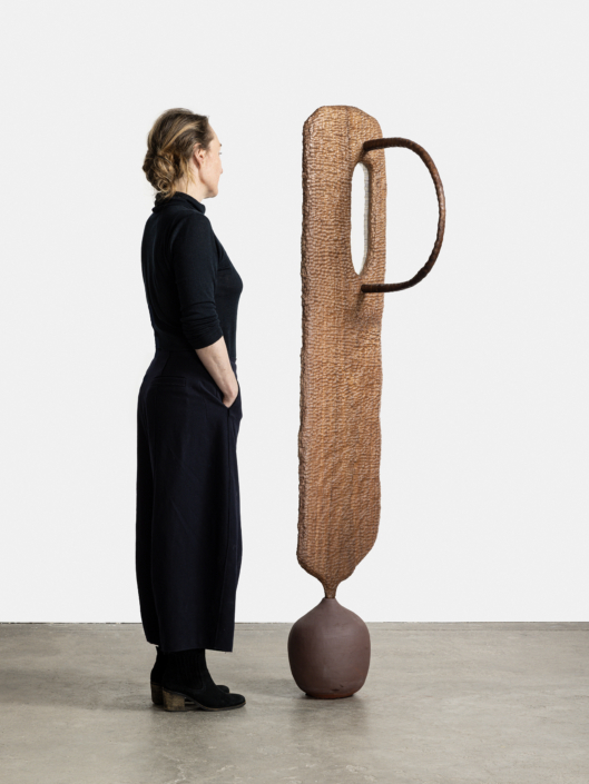 Marie Herwald Hermann, Shared shapes, 2026, (Scale Reference), Mahogany, stoneware, and sinamay, 65″ x 16″ x 19″. Photography by Travis Roozée